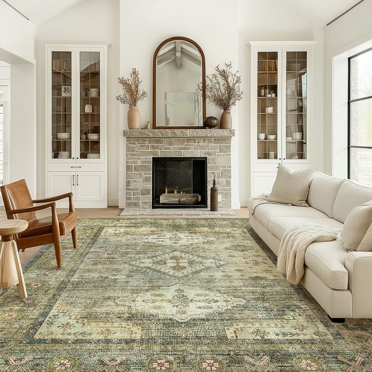 a living room filled with furniture and a large rug on the floor in front of a fire place