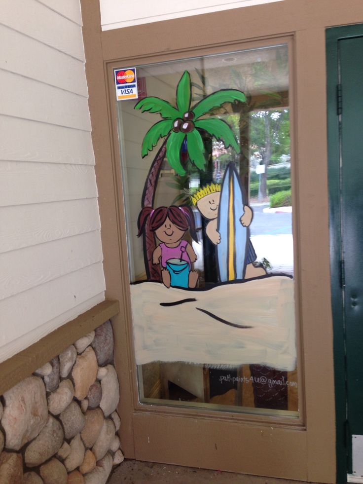 a glass door with a painting of two people holding surfboards and a palm tree