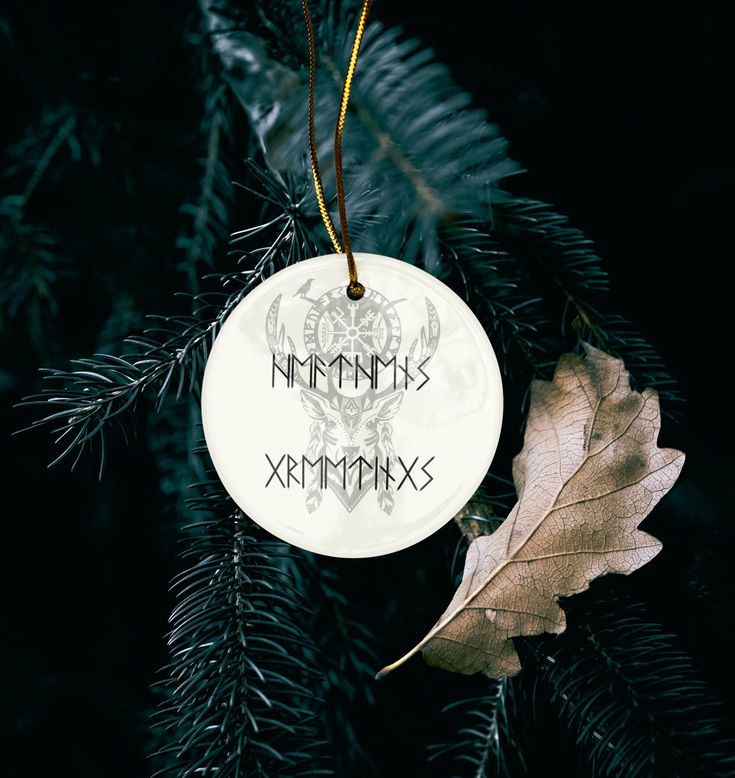 a white ornament hanging from a christmas tree