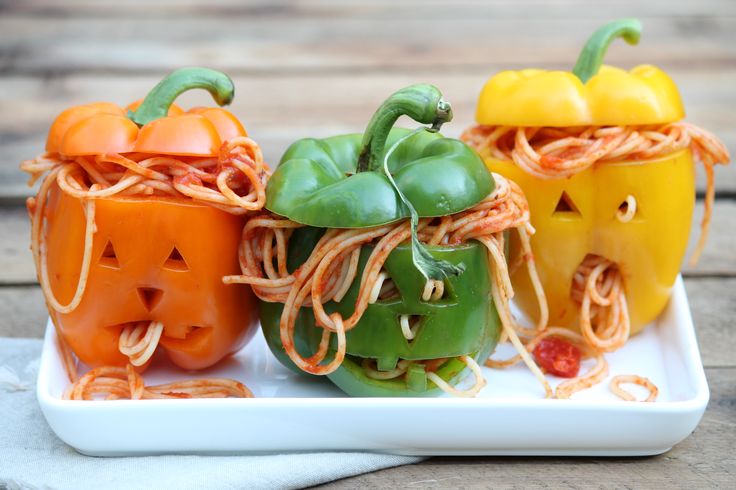 three small pumpkins are on a plate with string wrapped around the heads and eyes