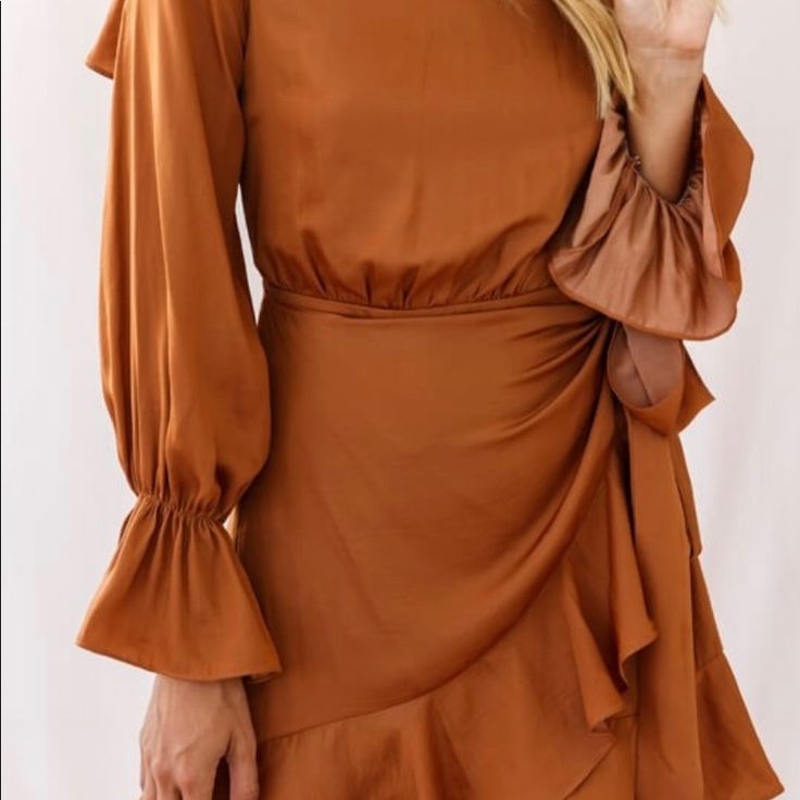 Flowy Camel Colored Wrap Dress. Open Back For Flirty Fun! Brown Long Sleeve Mini Dress For Date Night, Chic Brown Mini Dress For Brunch, Chic Brown Mini Dress With Ruffles, Chic Brown Dress For Date Night, Brown Ruffled Midi Dress For Party, Brown Ruffled Midi Dress, Chic Brown Long Sleeve Dress, Brown Ruffled Midi Dress For Day Out, Brown Long Sleeve Mini Dress For Summer