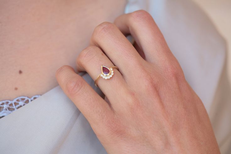 "A delicate 14K yellow gold ring with a beautiful high-quality Ruby stone. \"Ruby is a stone of nobility, considered the most magnificent of all gems, the queen of stones and the stone of kings\". This ring has 8 tiny gold dots at the base of the drop-shaped Ruby that gives this ring a unique vintage and regal look. This Ruby ring is delicate and comfortable to wear and will be great for everyday use, as for a special occasion. This ring can be worn as a minimalist item or as a stacked ring. Thi Yellow Gold Ruby Halo Ring For Wedding, Ruby Wedding Ring With Rose Cut Diamonds, Heirloom Ruby Ring For Proposal, Yellow Gold Ruby Halo Ring For Promise, Ruby Diamond Ring With Rose Cut For Proposal, Ruby Birthstone Promise Ring With Rose Cut Diamonds, Proposal Gold Ruby Rings, Wedding Rings With Rose Cut Diamonds And Ruby, Fine Jewelry 14k Gold Ruby Wedding Ring