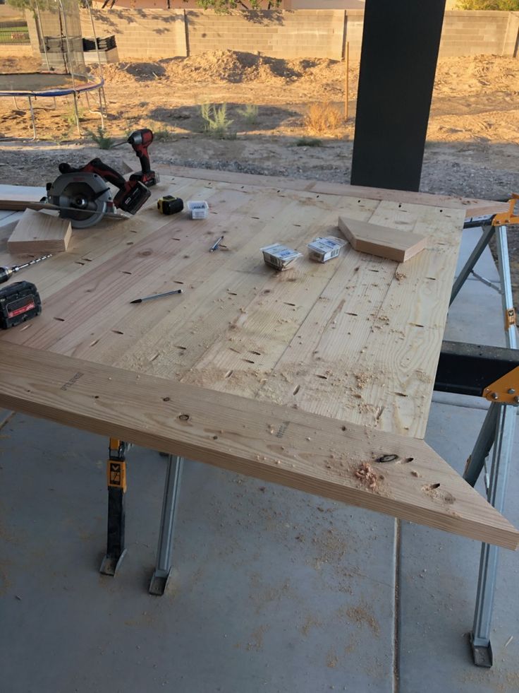 a wooden table being built with tools on it