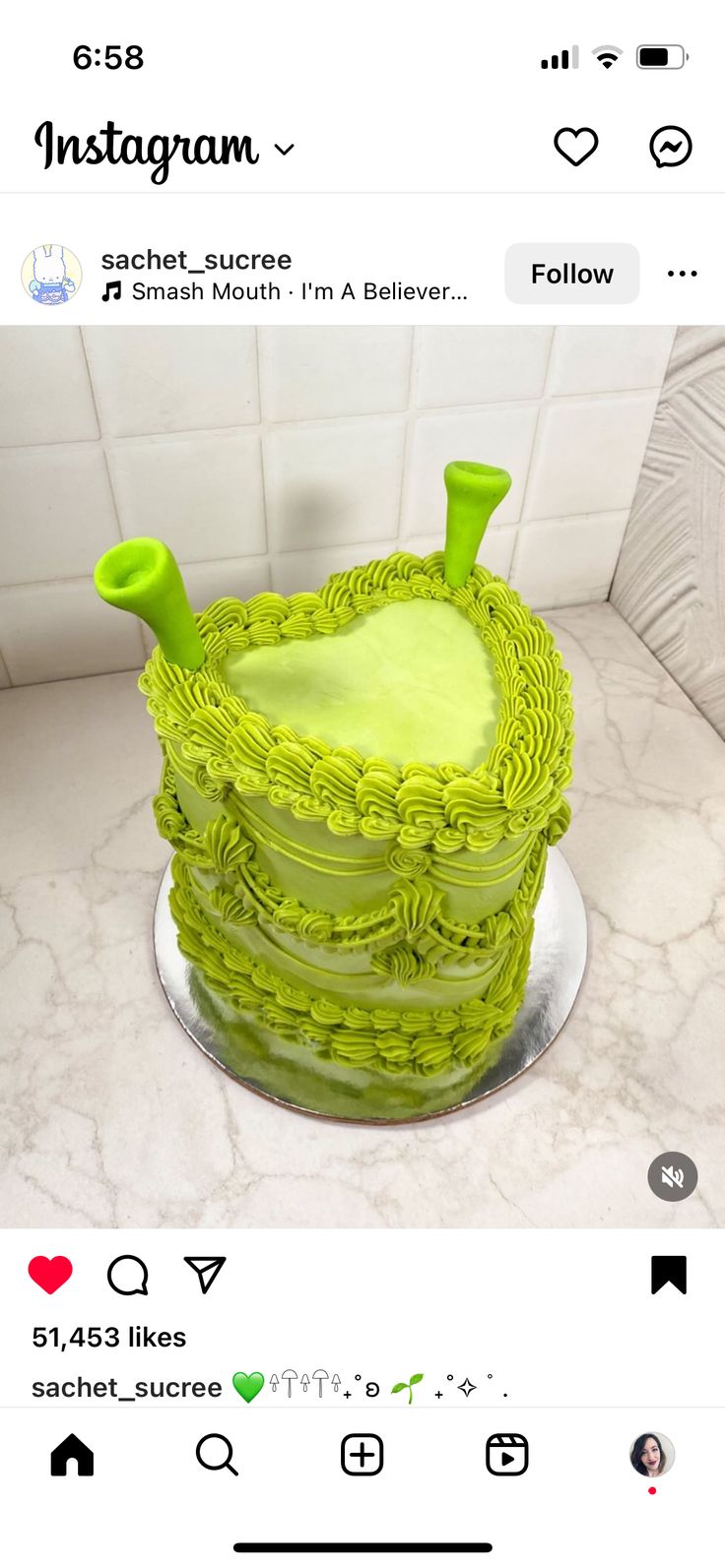 a green cake sitting on top of a counter next to a white tile wall with the words instagram