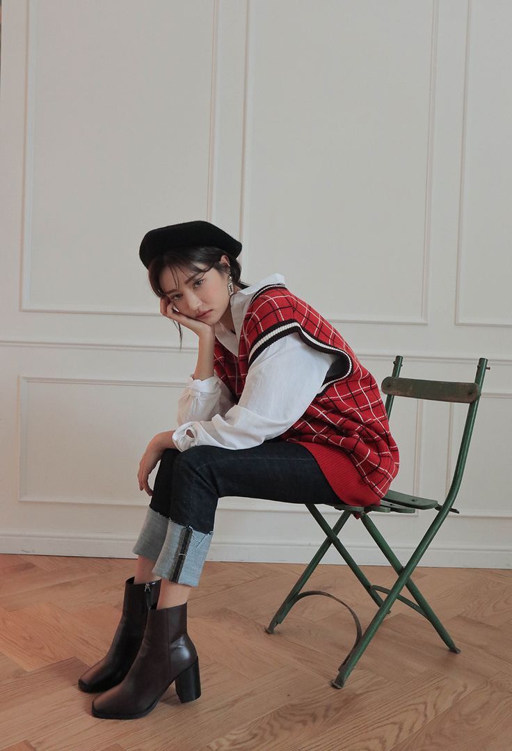 a woman sitting in a chair with her hand on her mouth