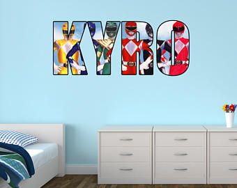 the word kybo is made up of photos in different colors and font styles on a blue wall above a white bed