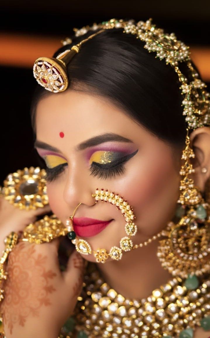 a woman with makeup and jewelry on her face