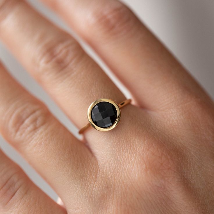 Natural black onyx 14K solid gold ring for women. A delicate black onyx gemstone ring, ideal for stacking for every woman who loves elegance. An excellent choice for anniversary gift or Valentine's gift for her by Kyklos. 100% handcrafted with love! D E T A I L S ● Metal: 14K solid gold, 14K white gold or 14K rose gold ● Gemstone: Black Onyx, briolette cut ● Stone Diameter: 8mm (0.31in), 10mm (0.4in) and 12mm (0.5in)  R I N G ∙ S I Z I N G For General Reference: ● we use standard US Ring Sizing Black Birthstone Ring Gift, 14k Gold Black Round Band Jewelry, Black 14k Gold Round Band Jewelry, Black 14k Gold Band, Black Round Band Fine Jewelry, Black Birthstone Rings, Black 14k Gold Jewelry With Bezel Setting, 14k Gold Black Gemstone Rings, Modern Black Jewelry With Bezel Setting