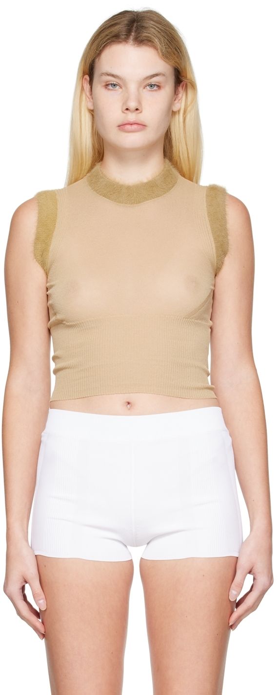 Semi-sheer knit cotton and nylon-blend tank top. Rib knit funnel neck, armscyes, and hem. Supplier color: Beige Fitted Fine Knit Crew Neck Tank Top, Spring Turtleneck Stretch Tank Top, Spring Stretch Turtleneck Tank Top, Stretch Turtleneck Tank Top For Spring, Sheer Stretch Tank Top, Fitted Turtleneck Tank Top For Layering, Sheer Stretch Nylon Tank Top, Sheer Sleeveless Nylon Tank Top, Sheer Fitted Mesh Tank Top