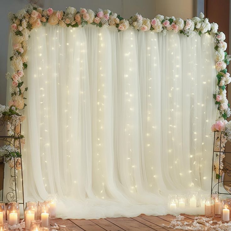 a wedding backdrop with flowers and candles