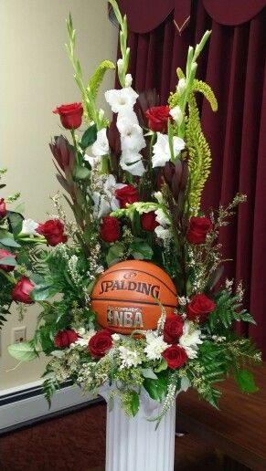 a white vase filled with flowers and a basketball