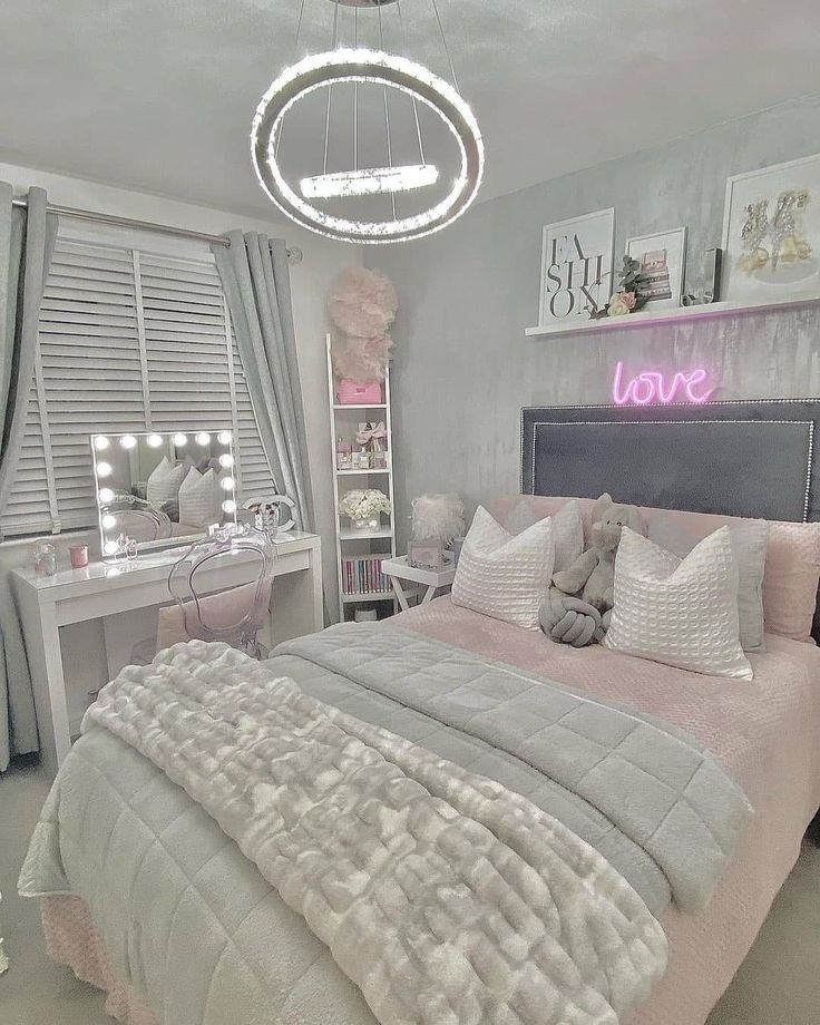 a bedroom decorated in pink and grey with white bedding