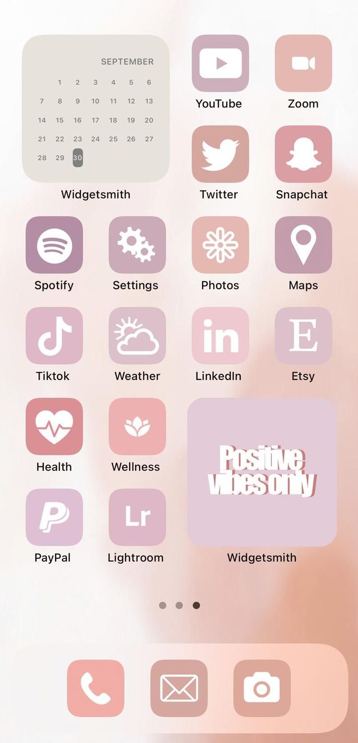 the pink and white phone screen is displaying icons