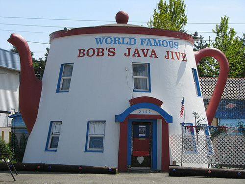 a giant teapot shaped like a house with the words bob's java jive painted on it