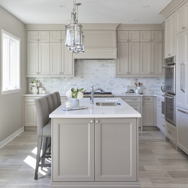 a kitchen with an island, sink and refrigerator in it's center area is shown