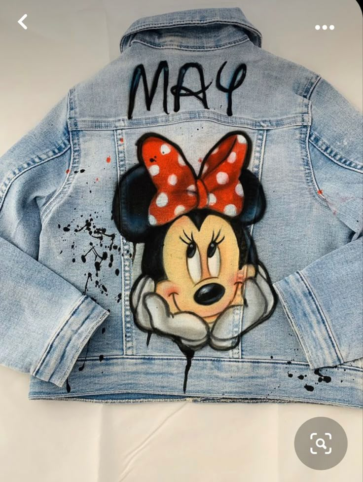 a jean jacket with minnie mouse painted on it