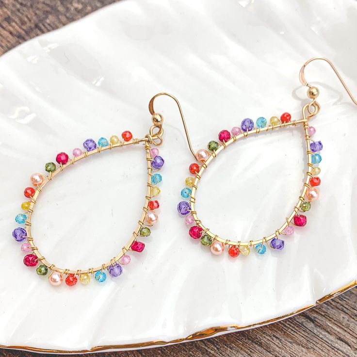 Colorful and light, everyday style hoops. 2” Trendy Rainbow Hoop Jewelry, Trendy Teardrop Earrings For Spring, Spring Trendy Teardrop Earrings, Trendy Colorful Hoop Jewelry, Trendy Small Hoop Earrings With Colorful Beads, Trendy Multicolor Hoop Earrings With Ear Wire, Trendy Spring Dangle Hoop Earrings, Trendy Dangle Hoop Earrings For Spring, Spring Trendy Dangle Hoop Earrings