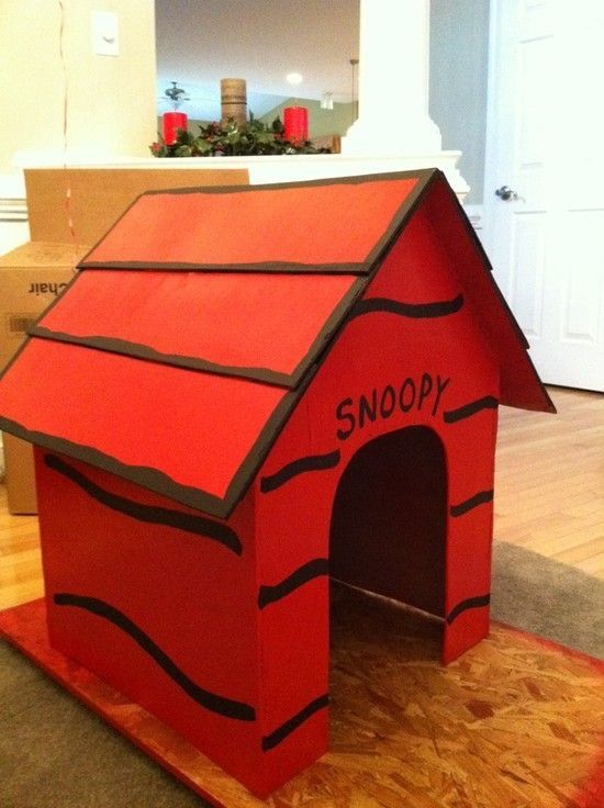 a dog house made out of cardboard with the word snoopy painted on it