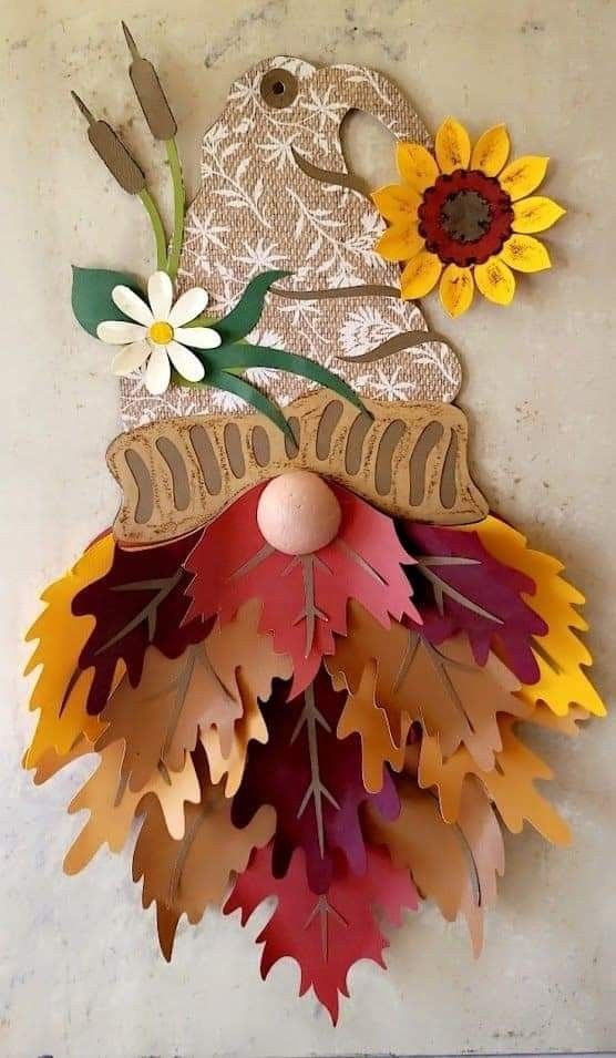 a clock made out of autumn leaves and sunflowers