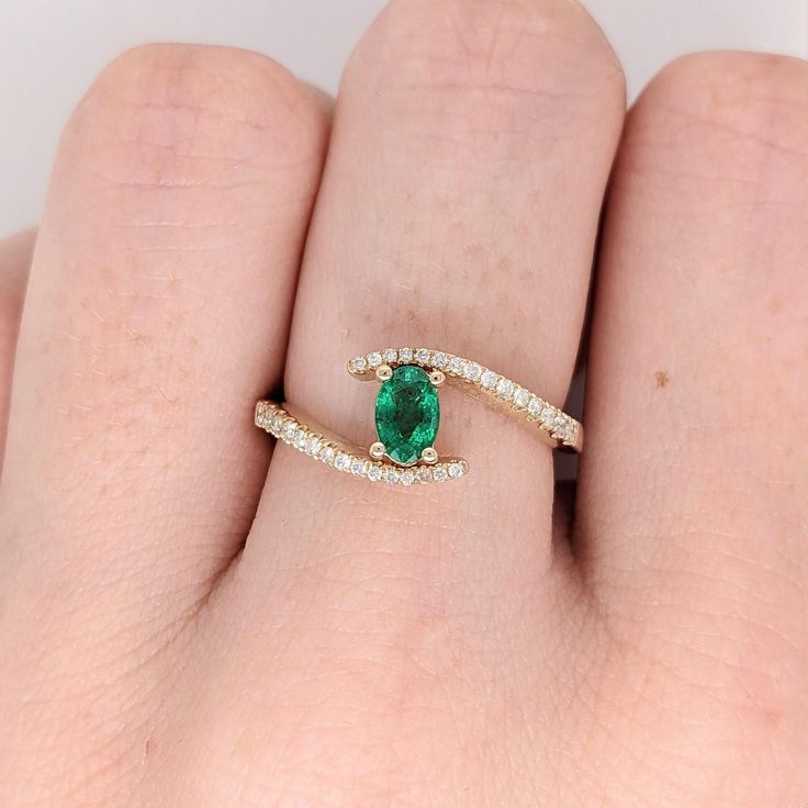 This beautiful classic ring features a Zambian emerald in solid 14k yellow gold. A fancy ring design perfect for an eye-catching engagement or anniversary. This ring also makes a beautiful birthstone ring for your loved ones. This ring is made with solid 14K Gold and naturally Earth-mined SI / G-H diamonds. As listed, this ring is ready to ship. If you're interested in purchasing this setting with a different center stone please message us! Emerald Solitaire Diamond Ring With Round Band, 14k Gold Emerald Ring With Brilliant Cut For Promise, Fine Jewelry Emerald Ring With Center Stone For Promise, Fine Jewelry Emerald Promise Ring With Center Stone, Emerald Open Ring With Center Stone, Emerald Solitaire Birthstone Ring In Fine Jewelry Style, Fine Jewelry Emerald Solitaire Birthstone Ring, Diamond Open Ring For May Birthstone, Fine Jewelry Emerald Solitaire Ring For May Birthstone