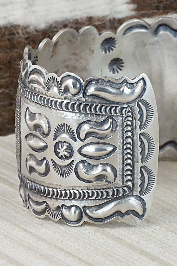 This sterling silver bracelet was made by Navajo silversmith Eugene Charley. The inside is signed and stamped sterling.Size: 5 3/4" (will fit up to a 7" wrist)Gap: 1 1/4"Width: 1 1/2"Free shipping on all orders! We ship with USPS and always include tracking. All orders ship within a day of payment.Returns are accepted up to 30 days after you receive your order. Just send us a message. Our shop offers cash back or store credit. The item must be returned in new condition. Western Sterling Silver Cuff Bracelet With Concho, Western Silver Cuff Bracelet With Concho, Western Silver Concho Cuff Bracelet, Bohemian Antique Silver Sterling Silver Bracelet, Bohemian Antique Sterling Silver Bracelet, Artisan Silver Bracelet With Stamped Details, Western Sterling Silver Cuff Bracelet Gift, Western Sterling Silver Cuff Bracelet, Western Style Sterling Silver Cuff Bracelet