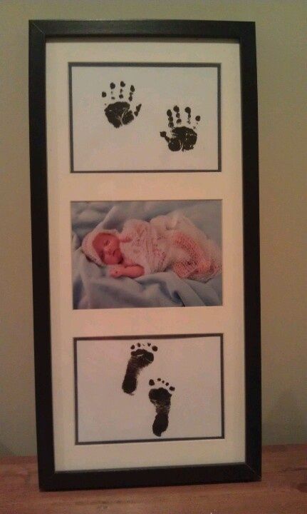 a baby's hand and foot prints are displayed in a frame