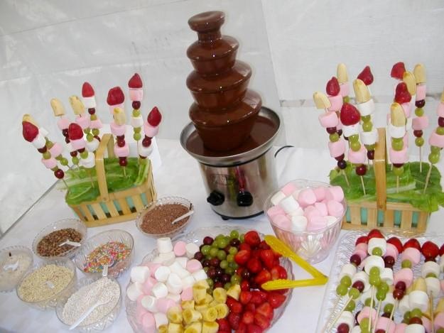 a table topped with lots of desserts next to a potted plant on top of a stove