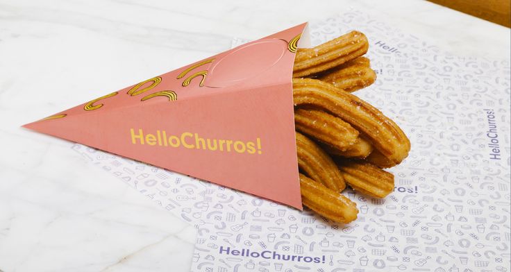 a paper cone with churros in it sitting on top of a white table