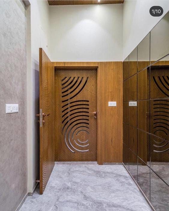 two wooden doors in a bathroom with mirrors on the wall and marble flooring below them