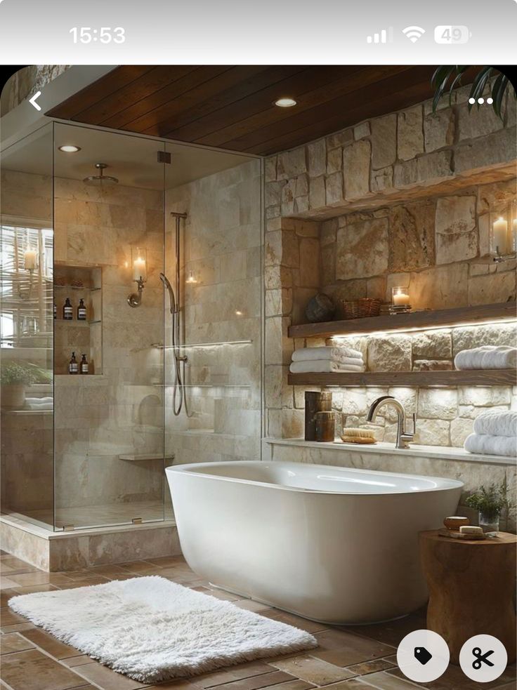 a bathroom with stone walls and flooring, including a large bathtub in the center