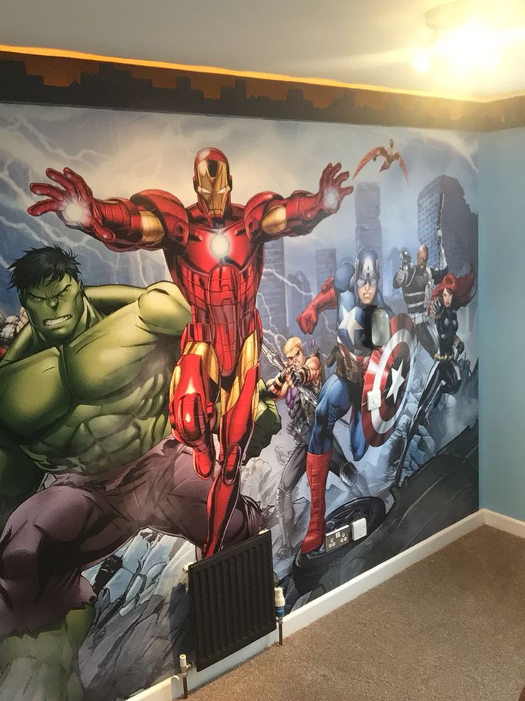 the avengers mural is painted on the wall