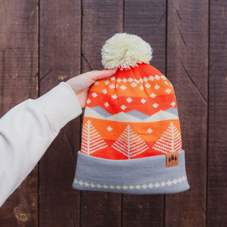 ALL SALES FINAL This Winter Sunset Pom Beanie is sure to warm your head and soul! Combining the cozy comfort of a beanie with a vivid, winter sunset design, it's the perfect way to brighten up the coldest of days. Embrace the cooler weather in style! A Montana Scene Original Design. All designs are property of The Montana Scene. All rights reserved.All of The Montana Scene apparel is designed and printed locally in Montana. Come visit our storefront locations! Bigfork * Whitefish * Missoula * Ka Warm Nordic Hats For Outdoor, Winter Camping Cap, Nordic Style Warm Outdoor Hats, Cotton Winter Hat For Outdoor Activities, Winter Camping Hat, One Size Fits Most, Warm Nordic Beanie For Outdoor, One Size Fits Most Beanie For Fall Outdoor Activities, Multicolor Beanie For Outdoor, Cozy Multicolor Beanie For Outdoor