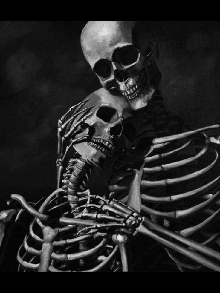 a skeleton is sitting in the dark with its arms crossed and head turned to the side