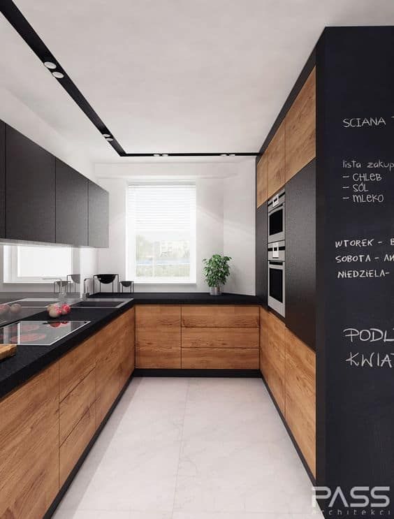 a modern kitchen with black counter tops and wooden cabinets, along with white flooring