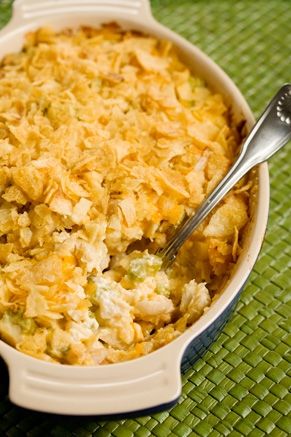 a casserole dish with chicken and rice in it on a green place mat