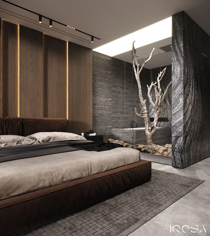 a large bed sitting in a bedroom next to a tall wooden tree on the wall