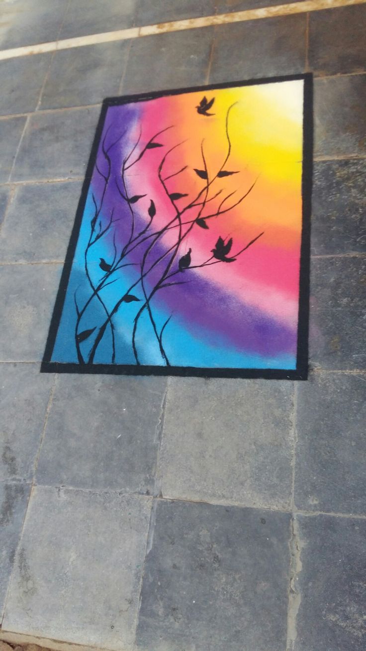 a painting on the ground with birds flying over it