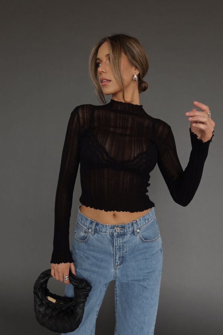 DETAILS: Our Brielle Sheer Long Sleeve Top is a statement piece! This top is completly sheer with long sleeves and a high neckline. It is lightweight with a ribbed look and texture to the fabric. We suggest pairing it with a bralette under. There is plenty of stretch and it fits true to size. Pair this top with any bottom for a cute look! CONTENT & CARE: SELF: 89% Viscose, 11% Nylon. SIZE & FIT: Model is 5'6" The model is wearing a size Small. Fits true to size The Fabric has stretch Chic High Neck Ribbed Tops, Chic Ribbed High Neck Top, Chic Crop Top With Sheer Sleeves For Fall, Ribbed Stretch Top For Party, Stretch Ribbed Top For Party, Chic Long Sleeve Pointelle Knit Crop Top, Stretch Ribbed Party Top, Cropped Tops With Sheer Sleeves For Fall, Sheer Long Sleeve Mesh Top For Date Night