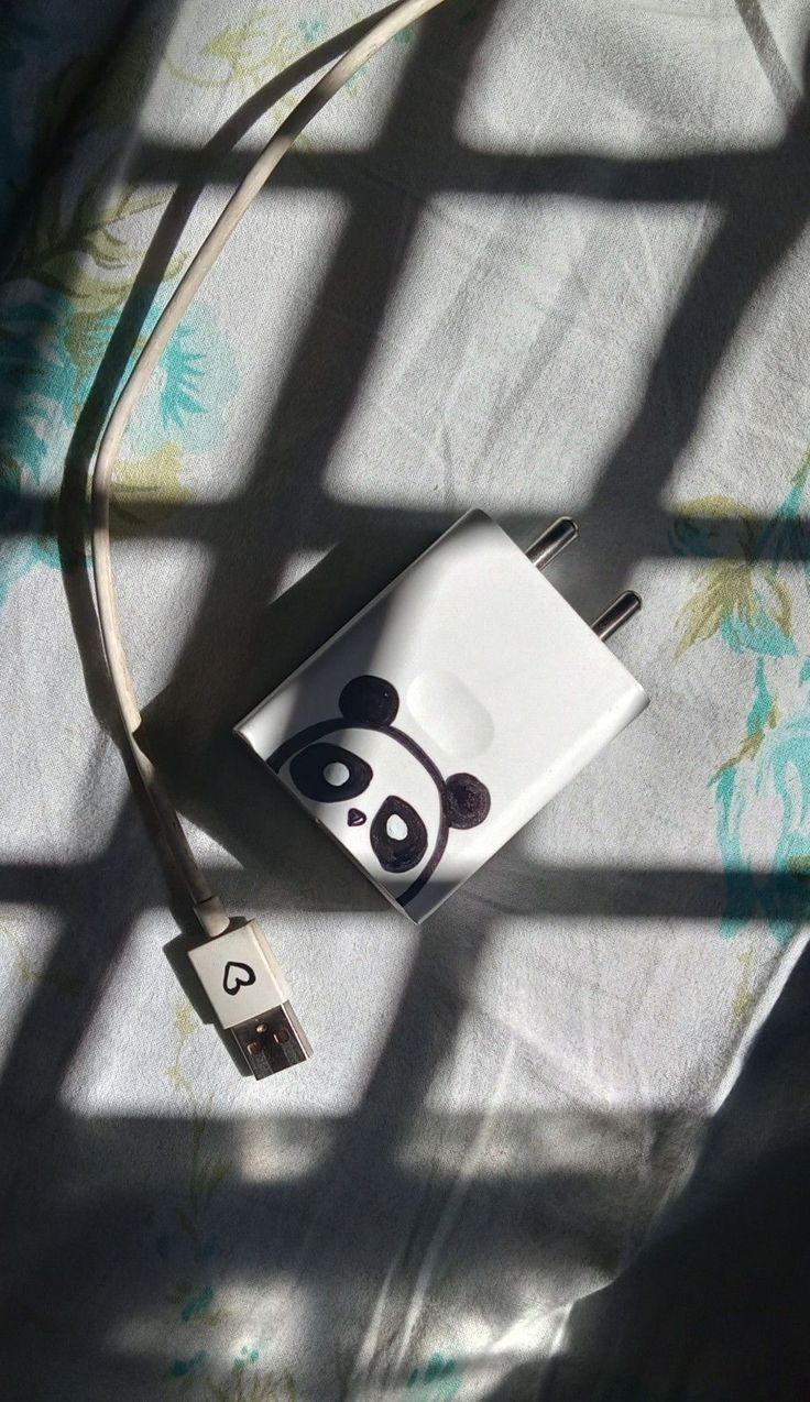 an ipod charger sitting on top of a bed