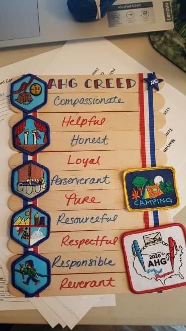 a bunch of badges that are on top of some paper with words written in them