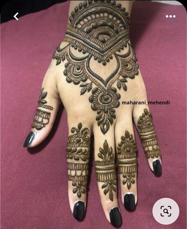 henna tattoo on the palm of someone's hand