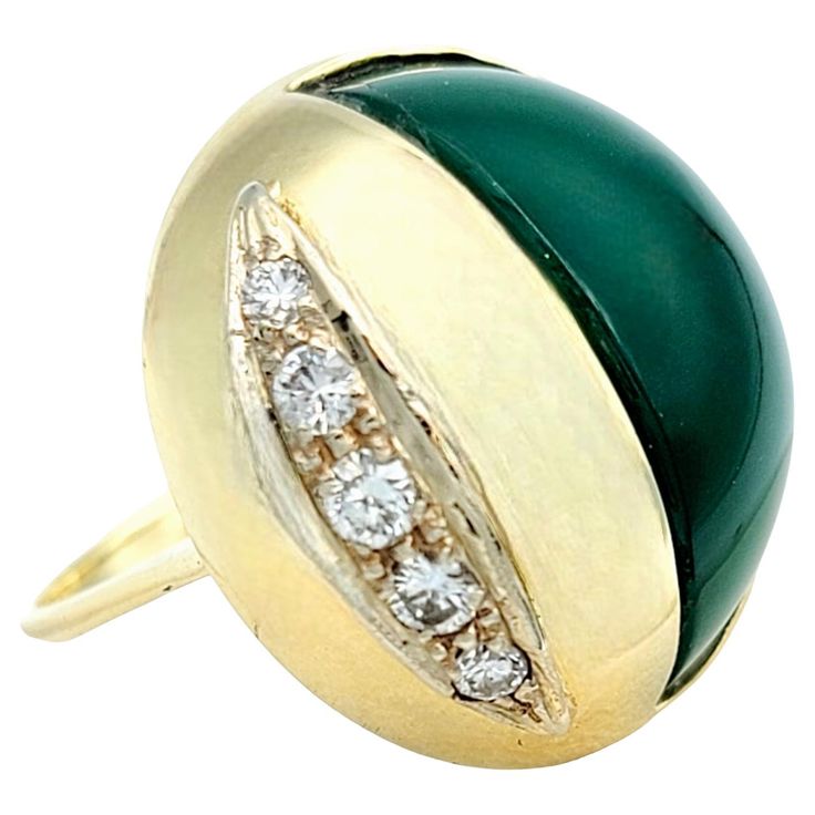 Ring Size: 7.75 Introducing a stunning 14 karat yellow gold cocktail ring that embodies elegance and sophistication in a modern design. This unique piece features a captivating dome-shaped structure that gracefully adorns your finger, creating an aura of opulence and charm. The centerpiece of this enchanting ring is a half-oval cabochon chalcedony stone, its serene green hue evoking a sense of natural beauty. The chalcedony's smooth, polished surface glimmers softly in the light, adding a touch Luxury Yellow Gold Dome Ring With Cabochon, Formal Yellow Gold Oval Cabochon Diamond Ring, Luxury Domed Cabochon Rings, Modernist Formal Cabochon Rings, Modern Oval Cabochon Dome Ring, Luxury Yellow Gold Dome Ring With Oval Cabochon, Modern Yellow Gold Dome Ring With Cabochon, Art Deco Rings With Oval Cabochon Polished Finish, Formal 14k Gold Oval Cabochon Dome Ring