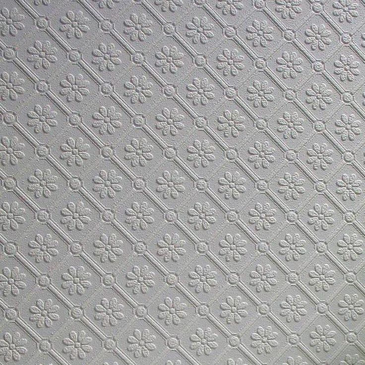 a close up view of the ceiling in a room with white tiles and flowers on it