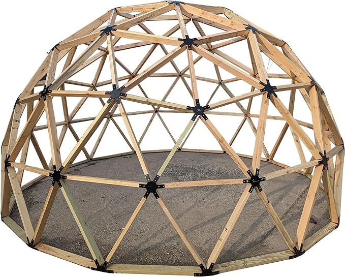 a circular structure made out of wooden sticks and wood planks on top of sand