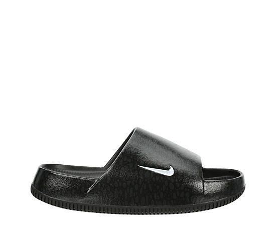 Nike Calm Women's Slide Sandal Dial down your stress in the Calm women's Slide Sandal from Nike. Featuring a water-friendly, single piece upper with a contoured fit for a soothing feel, this black & white Slide works everywhere from the streets to the pool. The foam footbed cradles your foot while the subtly textured outsole adds some traction. Synthetic upper  Slip-On  Seamless  Contoured footbed   Rubber outsole Sporty Waterproof Slides For Summer, Black Waterproof Slides For Summer, Black Slides For Swimming In Summer, Black Slides For Summer Swimming, Black Synthetic Sandals For Pool, Casual Black Pool Sandals, Black Waterproof Slides For The Beach, Nike Black Slides For The Beach, Nike Black Slides For Beach