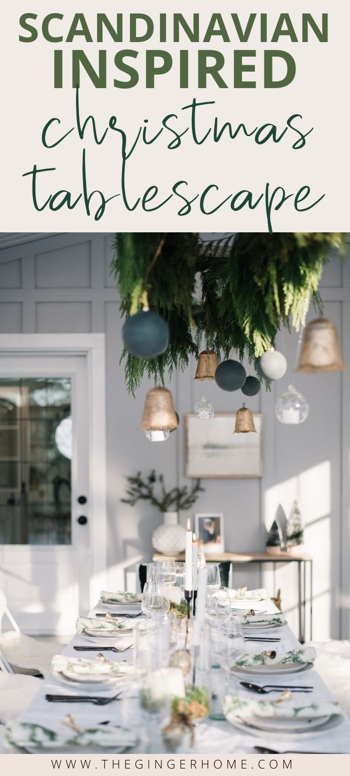 a table set for christmas dinner with the words scandinavian inspired christmas tablescape above it