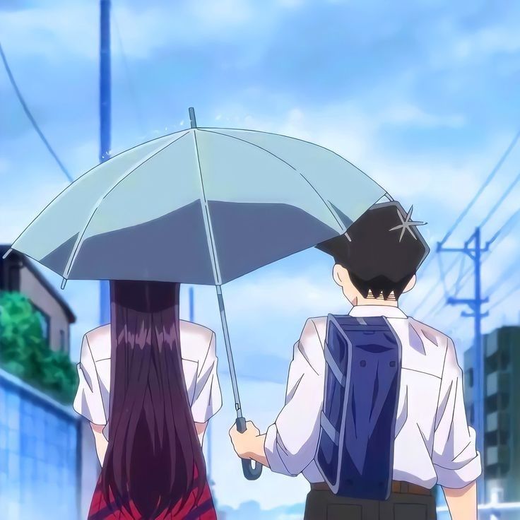 two people walking down the street with an umbrella