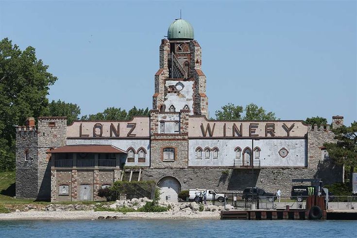 an old building with a clock tower next to the water