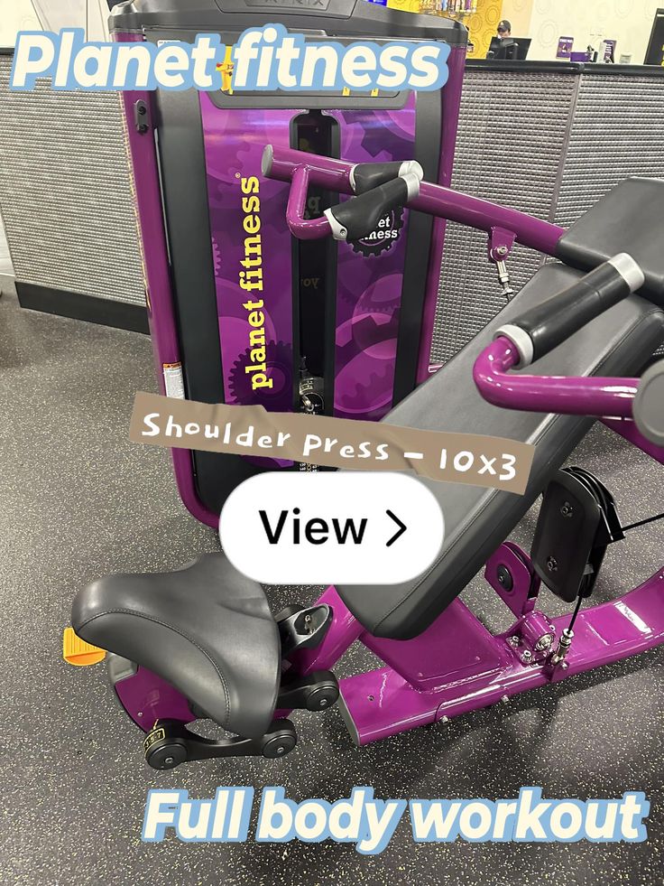 a purple exercise bike sitting on top of a floor next to a sign that says, full body workout