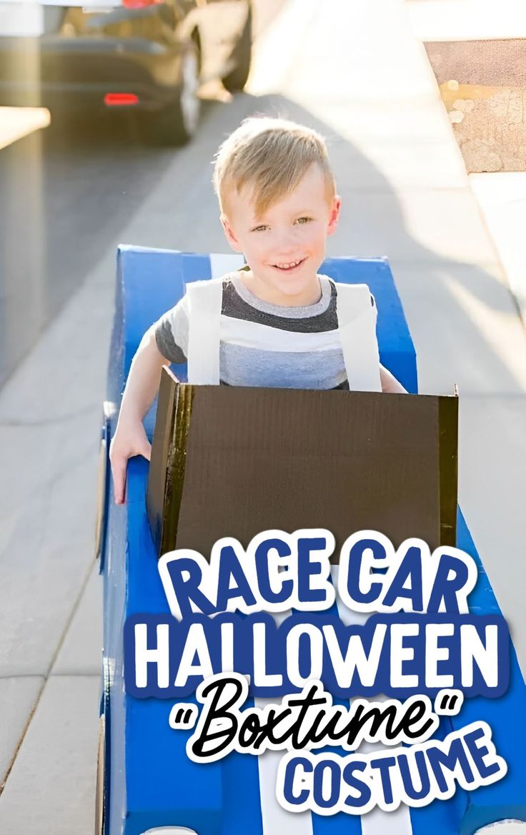 a young boy is sitting in a cart with a box on it and the words race car halloween costume